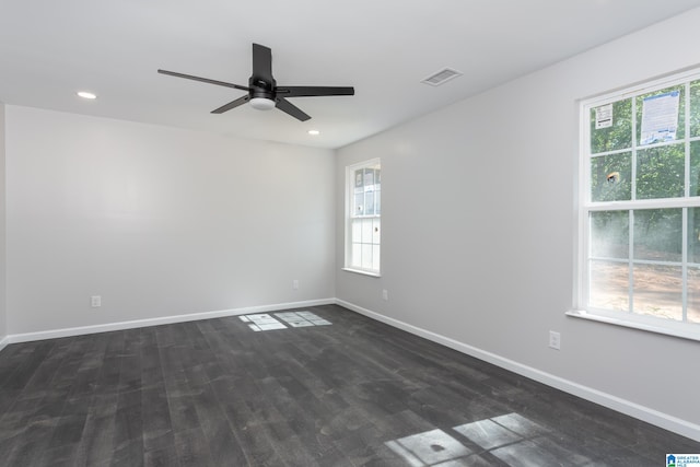 empty room featuring ceiling fan and dark wood-type flooring