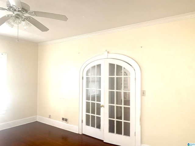 empty room featuring ceiling fan, dark wood-type flooring, french doors, and crown molding