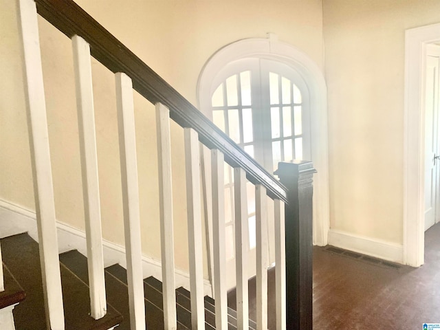 staircase featuring dark hardwood / wood-style floors