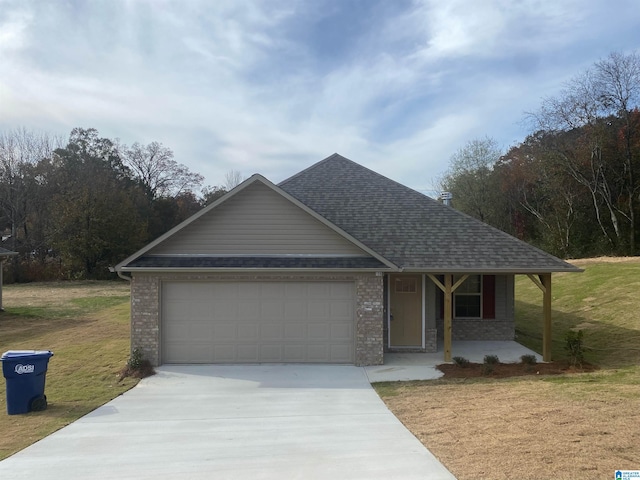 view of front of house featuring a porch, a garage, and a front yard