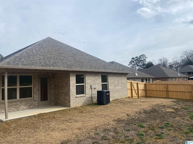 rear view of house with a patio and central AC unit