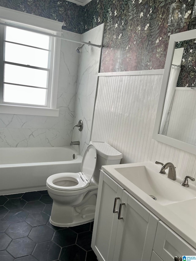 bathroom featuring toilet, bathtub / shower combination, vanity, wallpapered walls, and tile patterned flooring
