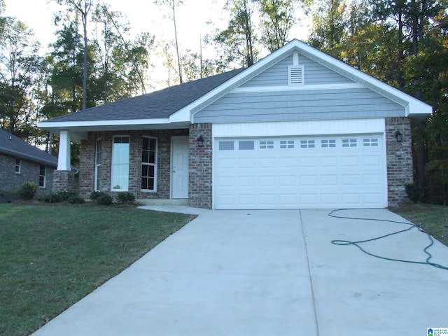 view of front of property featuring a front yard and a garage