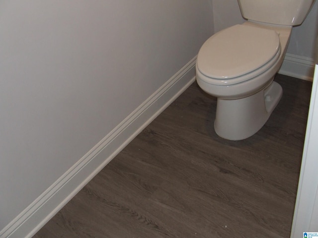 bathroom with hardwood / wood-style flooring and toilet