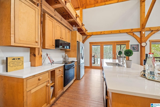 kitchen featuring light hardwood / wood-style floors, electric range, french doors, stainless steel fridge with ice dispenser, and sink