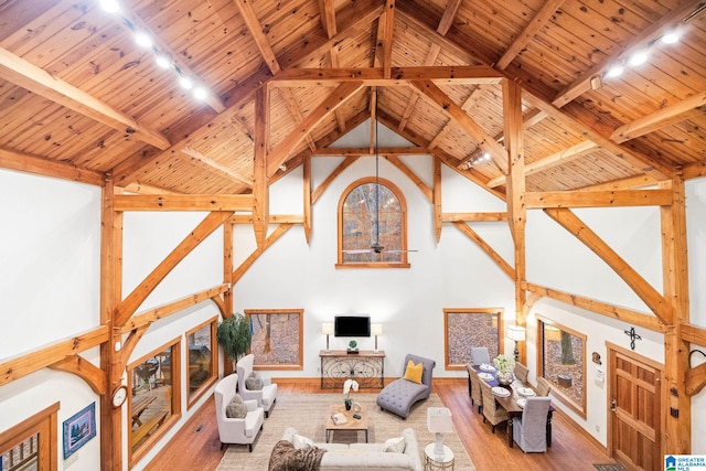 living room with wooden ceiling, dark wood-type flooring, high vaulted ceiling, and beamed ceiling