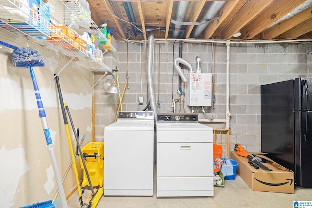 clothes washing area with water heater and washer and dryer