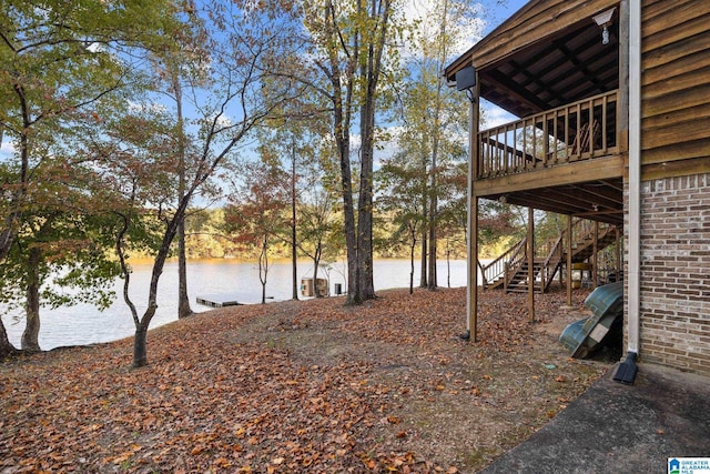 view of yard featuring a deck with water view