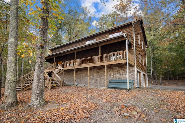 back of property featuring a wooden deck