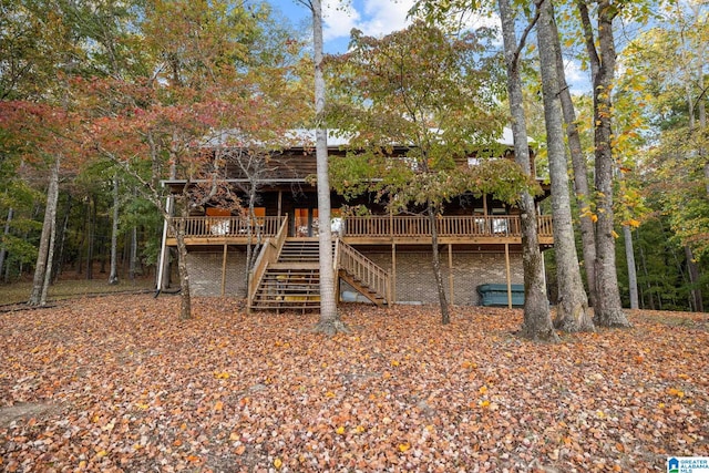 back of house featuring a wooden deck