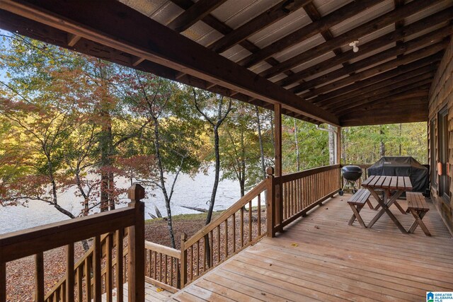 wooden terrace featuring a water view