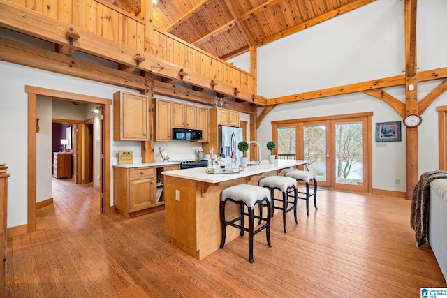 kitchen featuring high vaulted ceiling, light hardwood / wood-style floors, wood ceiling, and french doors