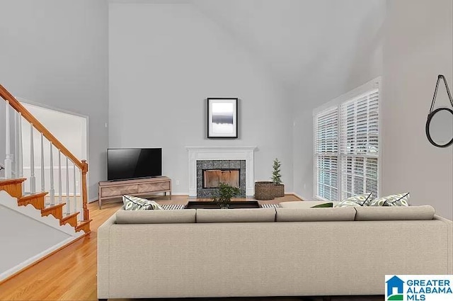 living room featuring light hardwood / wood-style floors and a high ceiling