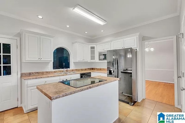 kitchen with a center island, white cabinetry, and black appliances