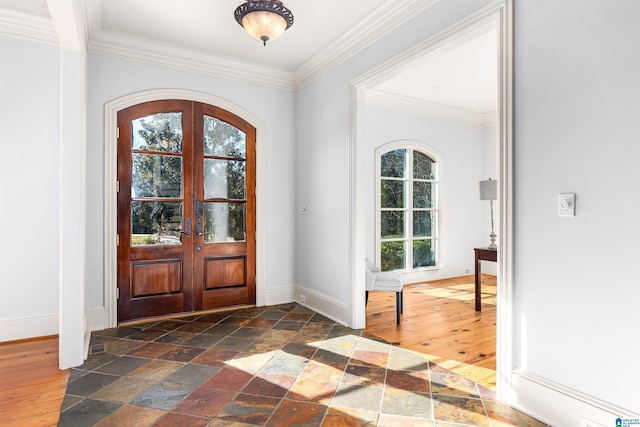 entrance foyer featuring french doors and crown molding