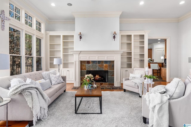 living room with a fireplace, hardwood / wood-style flooring, and crown molding