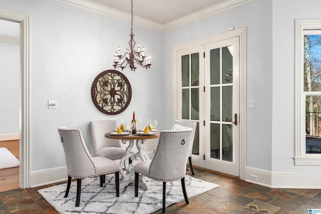 dining space with ornamental molding and an inviting chandelier