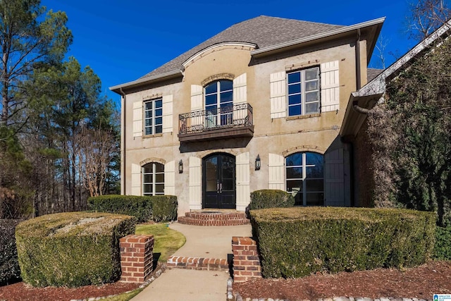 french country style house with a balcony