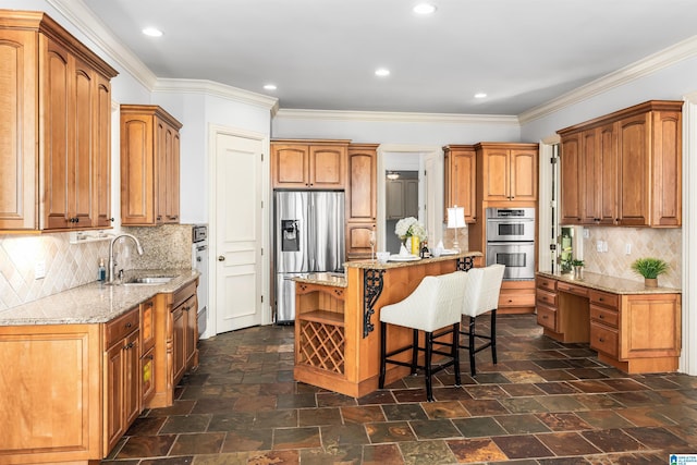 kitchen featuring decorative backsplash, a center island, sink, and appliances with stainless steel finishes