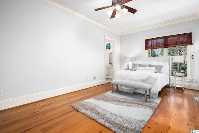 bedroom featuring connected bathroom, ceiling fan, wood-type flooring, and ornamental molding