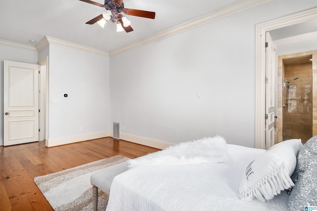 bedroom featuring ceiling fan, hardwood / wood-style floors, ensuite bathroom, and ornamental molding