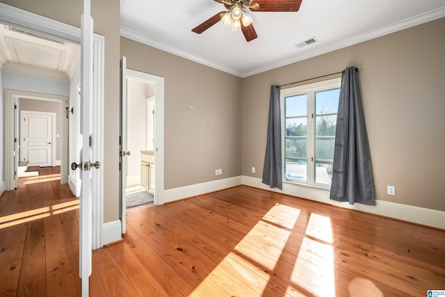 empty room with hardwood / wood-style flooring, ceiling fan, and ornamental molding