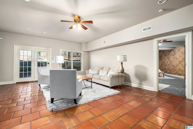 tiled living room featuring ceiling fan