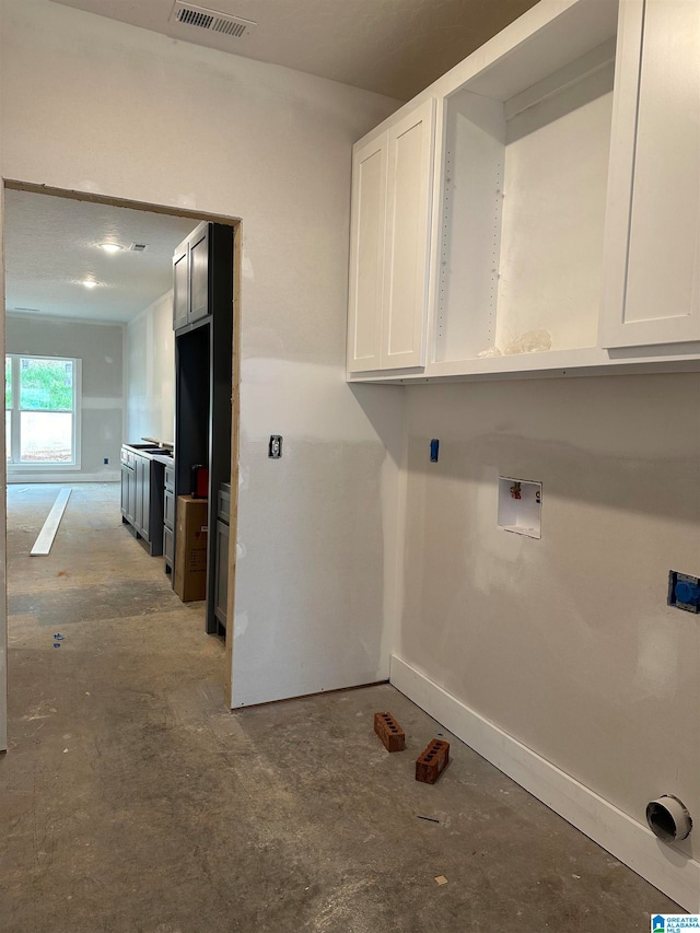 washroom with cabinets and hookup for a washing machine