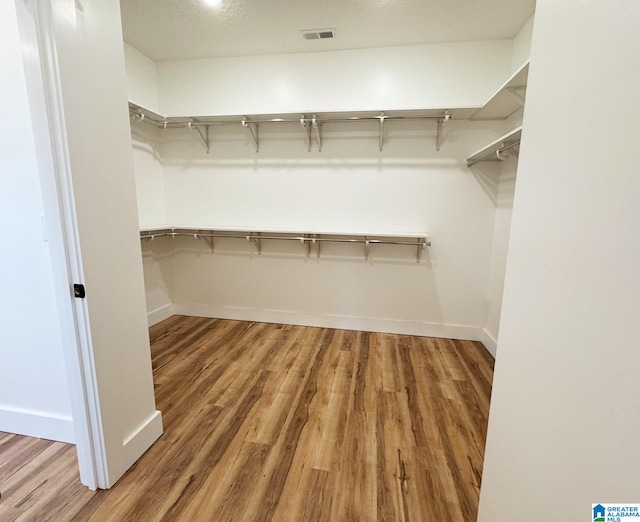 spacious closet featuring hardwood / wood-style flooring