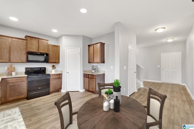 kitchen featuring light hardwood / wood-style floors and black appliances