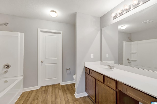 full bathroom with toilet, vanity, wood-type flooring, and bathing tub / shower combination