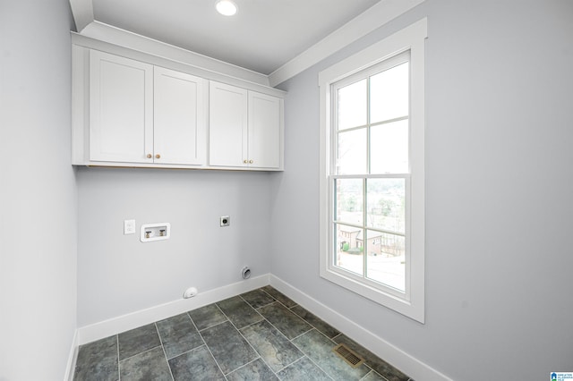 laundry room featuring hookup for a washing machine, cabinets, dark tile patterned flooring, electric dryer hookup, and hookup for a gas dryer