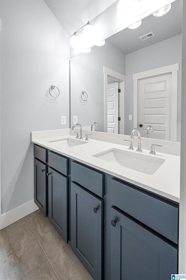 bathroom featuring tile patterned floors and double vanity