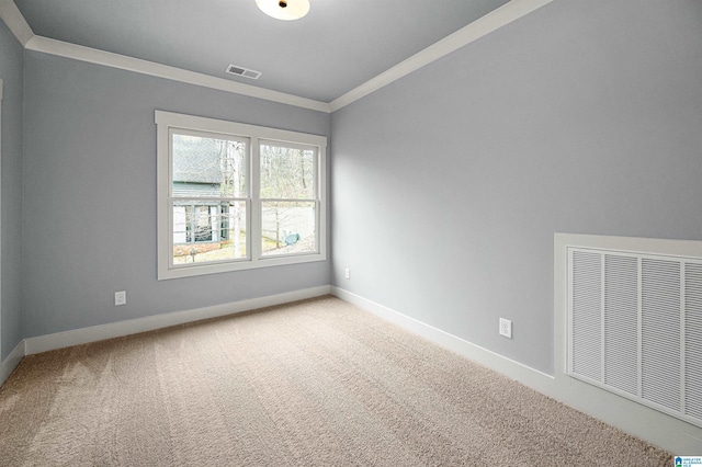 empty room featuring ornamental molding and carpet flooring