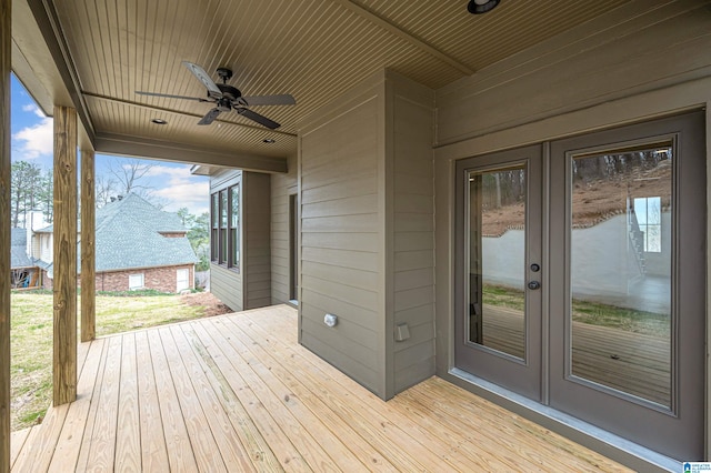 wooden deck featuring ceiling fan