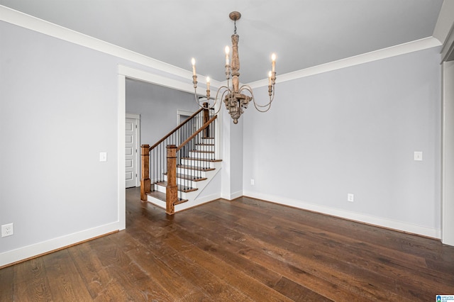 unfurnished room featuring a notable chandelier, ornamental molding, and wood-type flooring