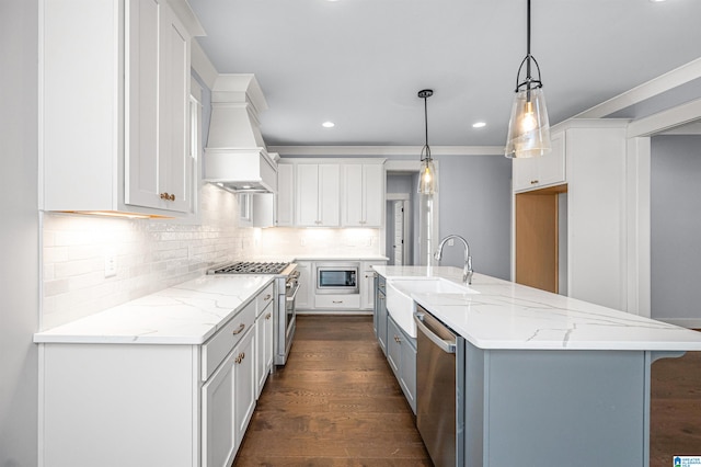 kitchen with hanging light fixtures, appliances with stainless steel finishes, dark wood-type flooring, and white cabinets