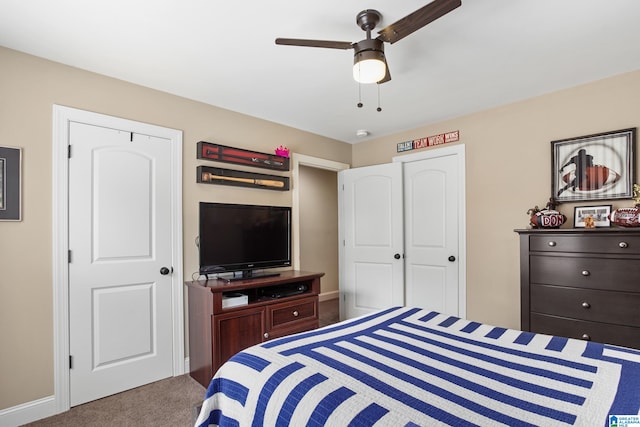 carpeted bedroom with ceiling fan and a closet