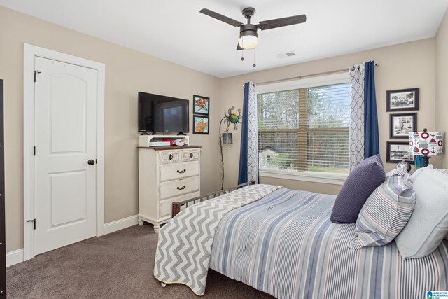 bedroom with ceiling fan and dark carpet