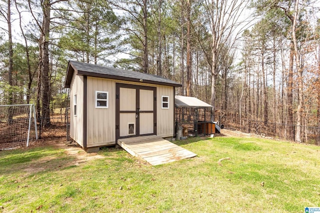 view of outbuilding featuring central AC unit and a lawn