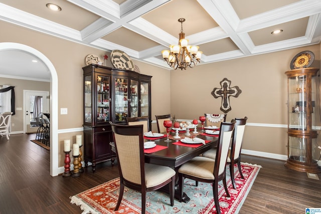 dining space featuring coffered ceiling, dark hardwood / wood-style flooring, crown molding, and an inviting chandelier