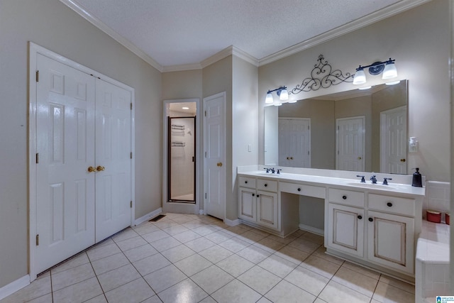 bathroom with tile patterned flooring, vanity, a textured ceiling, and ornamental molding