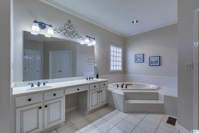 bathroom featuring tile patterned floors, tiled bath, a textured ceiling, vanity, and ornamental molding