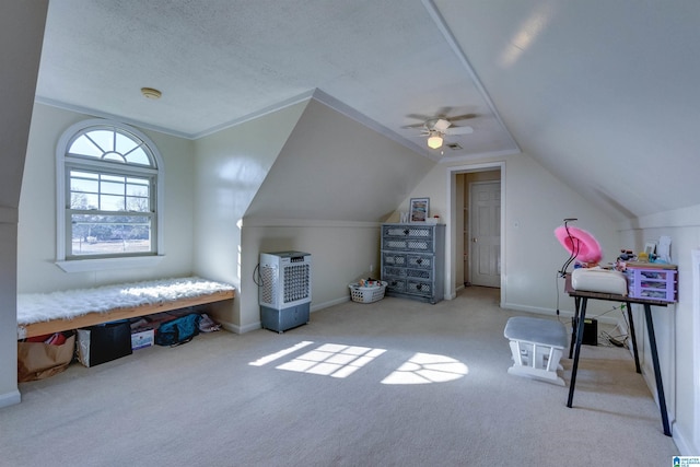 interior space with a textured ceiling, light colored carpet, ceiling fan, and lofted ceiling