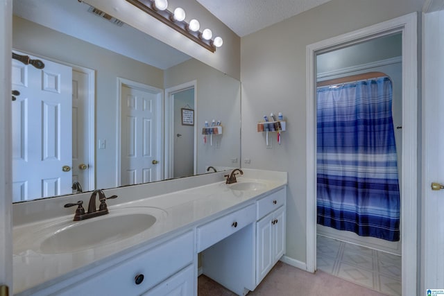 bathroom featuring vanity and a textured ceiling