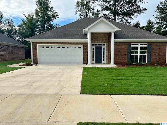 view of front facade featuring a garage and a front lawn