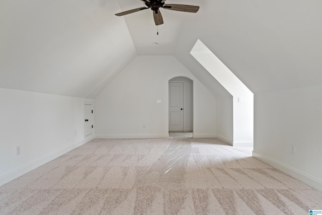 additional living space with light colored carpet, vaulted ceiling, and ceiling fan