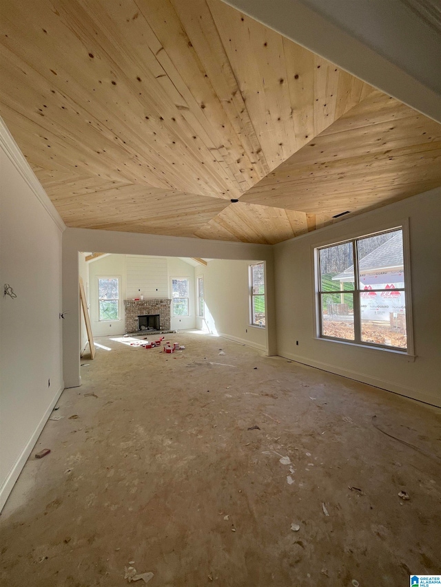 spare room with wooden ceiling, a brick fireplace, and lofted ceiling