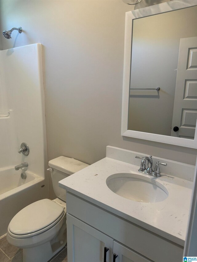 full bathroom with washtub / shower combination, vanity, toilet, and tile flooring