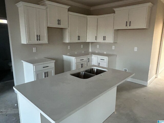 kitchen featuring sink, backsplash, white cabinetry, and a kitchen island